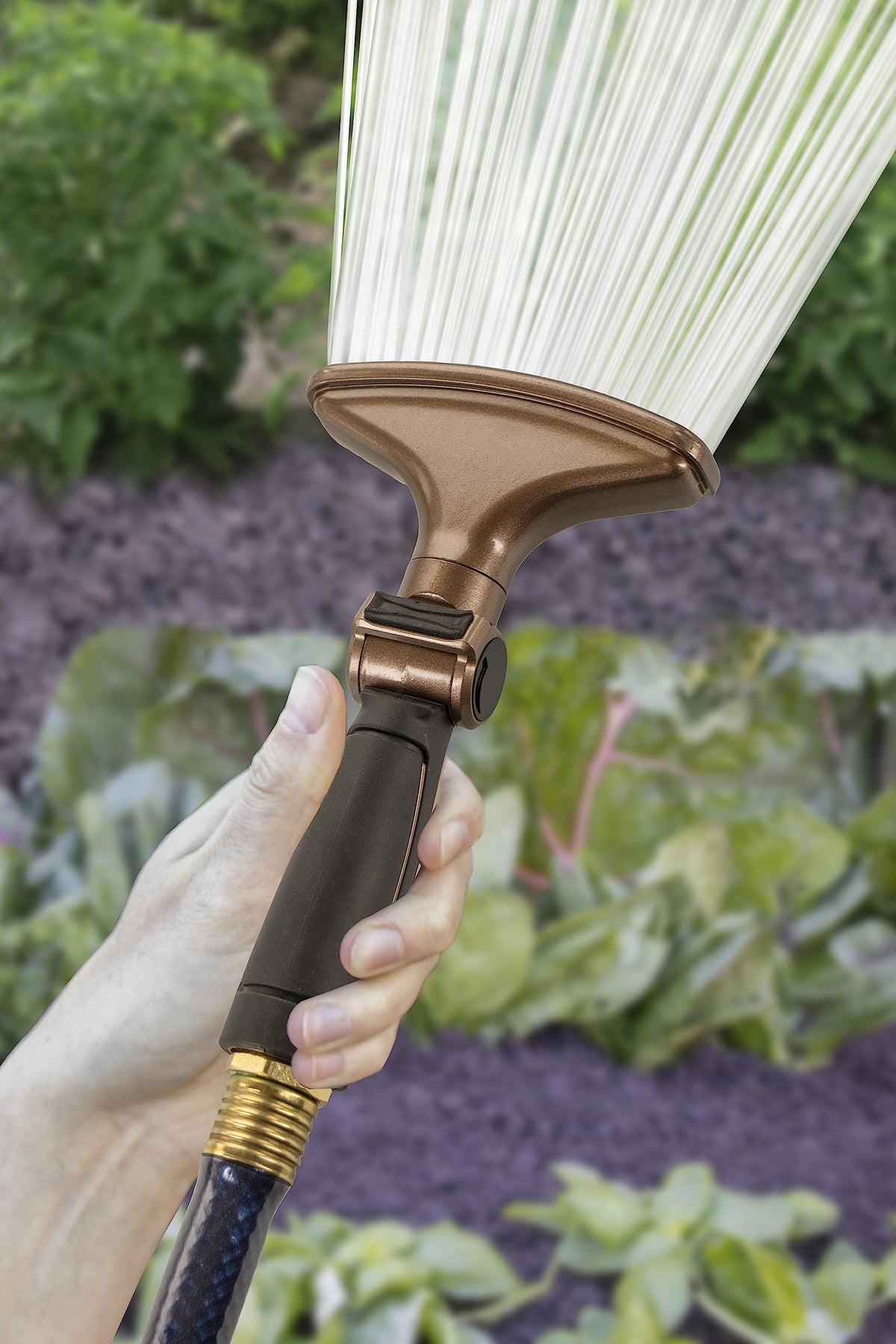 Orbit fan spray nozzle gardening scene demonstrating even coverage for a lush bed.