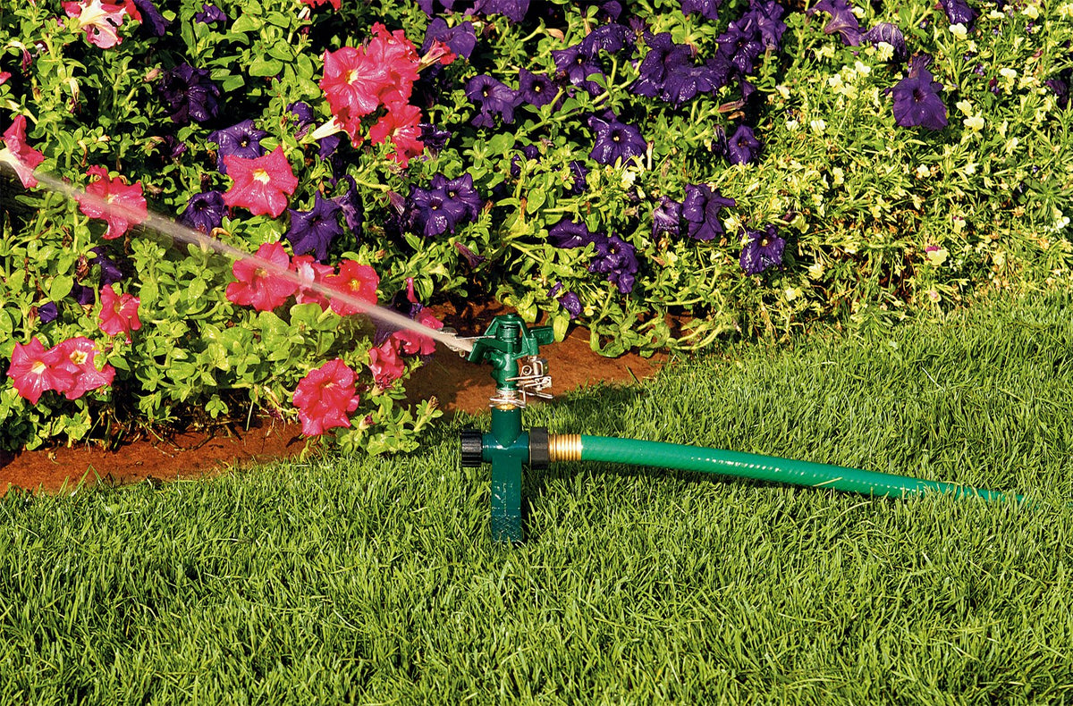 Orbit zinc step spike anchored in soil for stable watering.