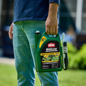 Ortho WeedClear Comfort Wand applying a precise spray on grass.