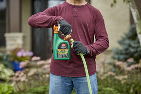 Ortho WeedClear hose-end sprayer being used for quick, even coverage on lawns.
