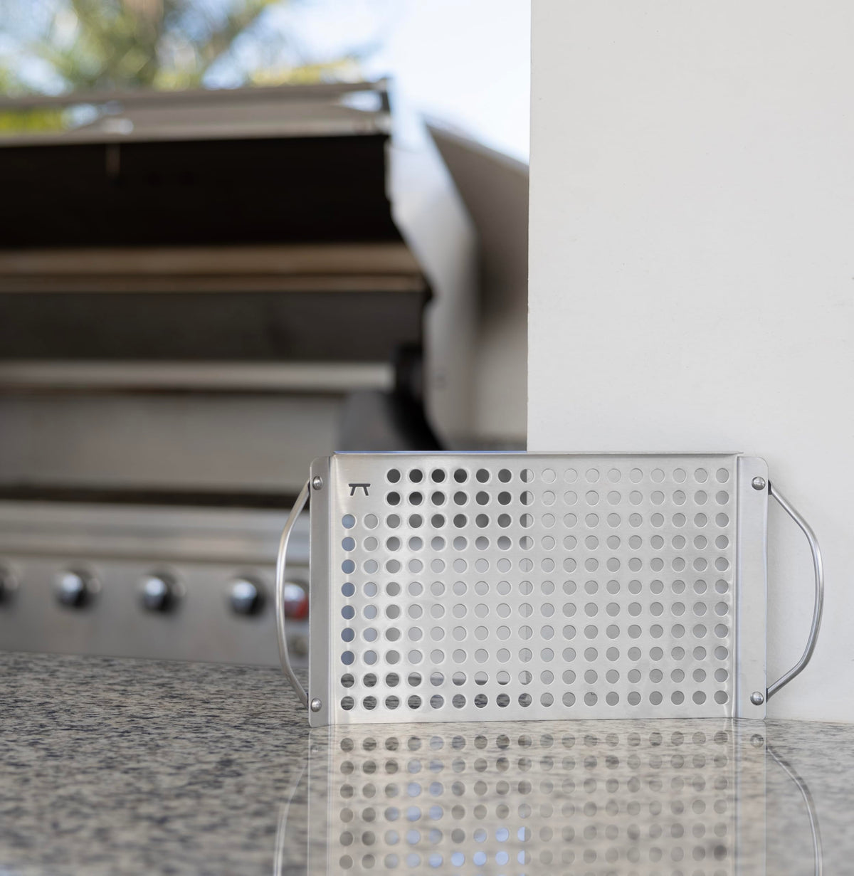 Outset grill grid with raised edges helps flip foods without spills on hot grills.