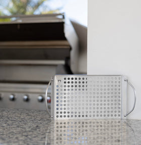 Outset grill grid with raised edges helps flip foods without spills on hot grills.