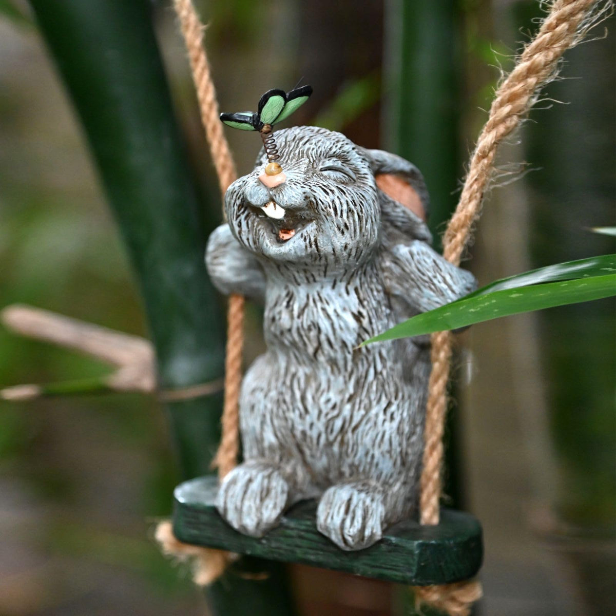 OwMell swinging bunny with butterfly enhances an airy garden atmosphere.