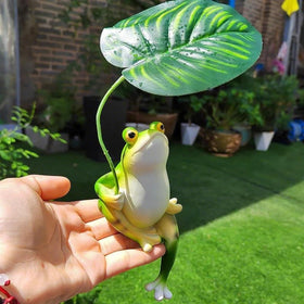 OwMell yard frog sculpture complements flower beds and greenery