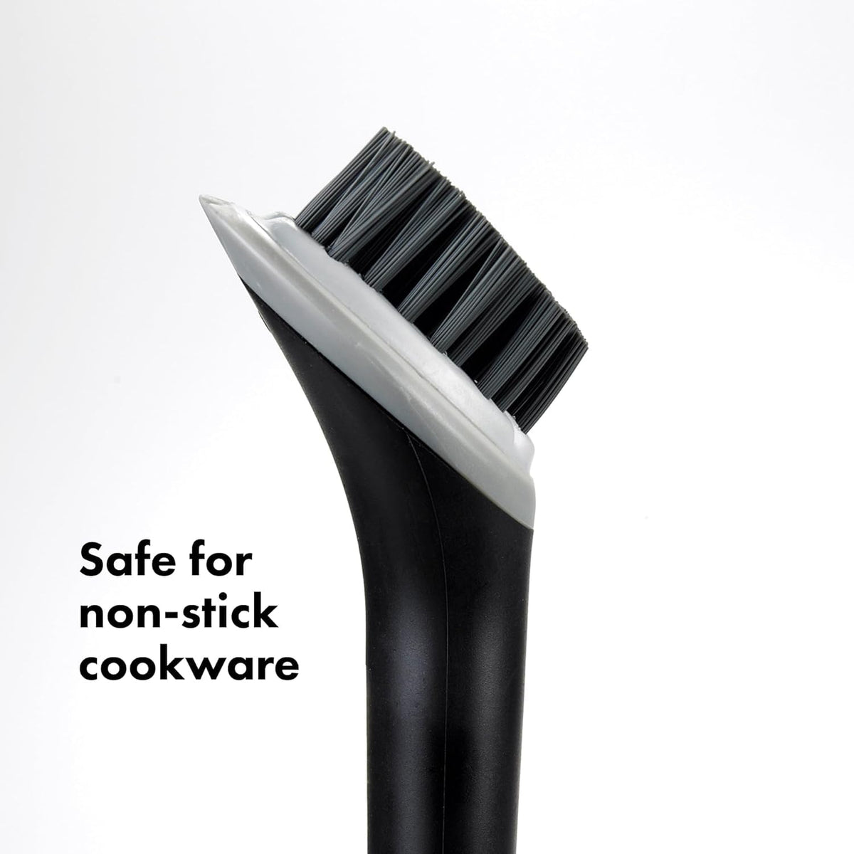 OXO Good Grips brush with silicone wiper close-up ready to scrape grease from ridges