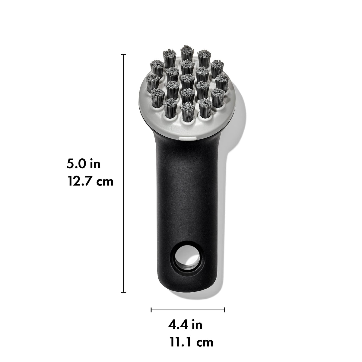 OXO Good Grips Cast Iron Brush highlights angled bristles for grooves and leverage.