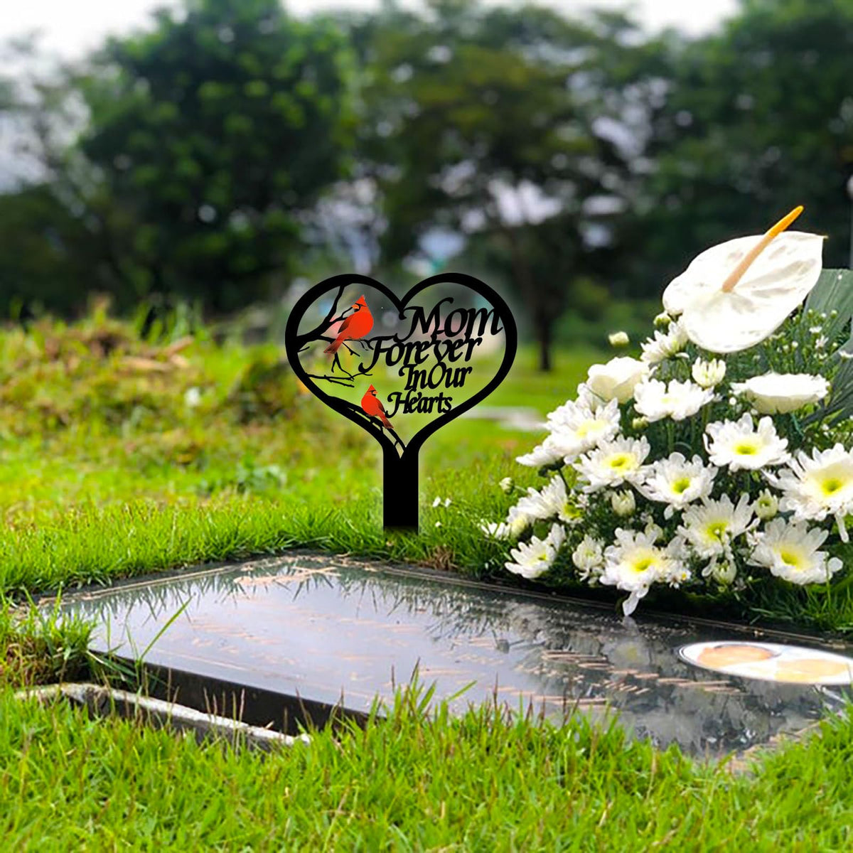 OZIO cardinal garden stake adds color to an outdoor memorial setting.