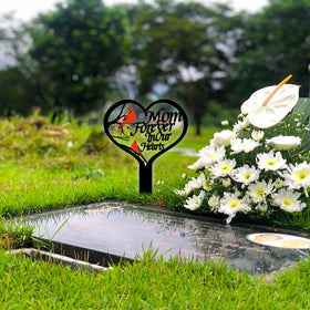 OZIO cardinal garden stake adds color to an outdoor memorial setting.