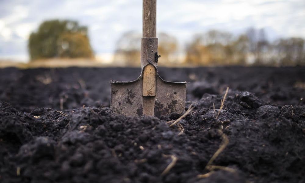 Park Seed Nature’s Aid inoculant being sprinkled into soil to start germination