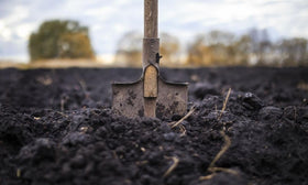 Park Seed Nature’s Aid inoculant being sprinkled into soil to start germination