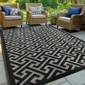 Pasamic waterproof outdoor rug 5x8 laid on a patio for all-weather protection and easy cleaning.