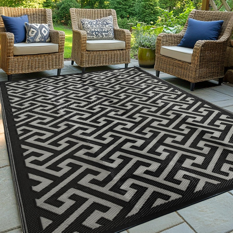 Pasamic waterproof outdoor rug 5x8 laid on a patio for all-weather protection and easy cleaning.