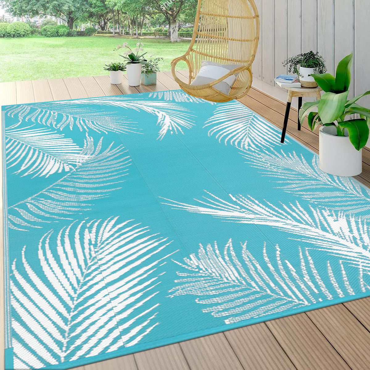 Pauwer leaf teal reversible outdoor rug showing dual-sided pattern for versatile decor