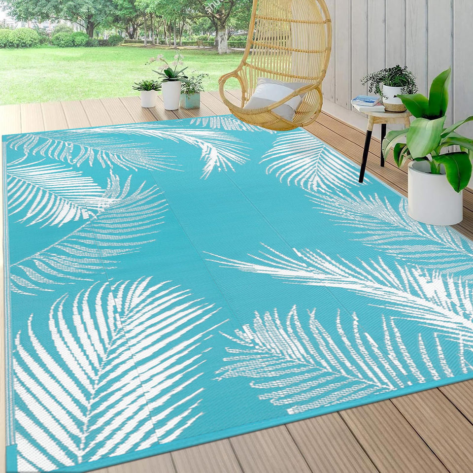 Pauwer leaf teal reversible outdoor rug showing dual-sided pattern for versatile decor