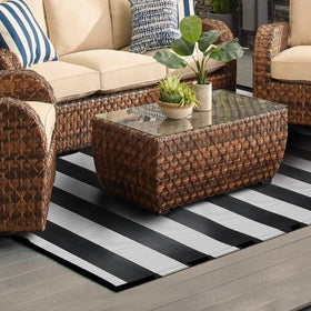 Pcinfuns easy-clean outdoor rug; hose it down or sweep away debris.
