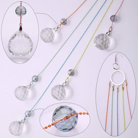 PEDOBO Crystal Ball Prisms Suncatcher hanging in a window brightens the room with color.