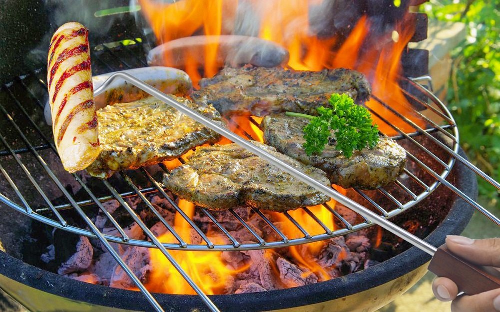 PEPKICN in-use flipping meats on grill demonstrates long 18-inch reach.