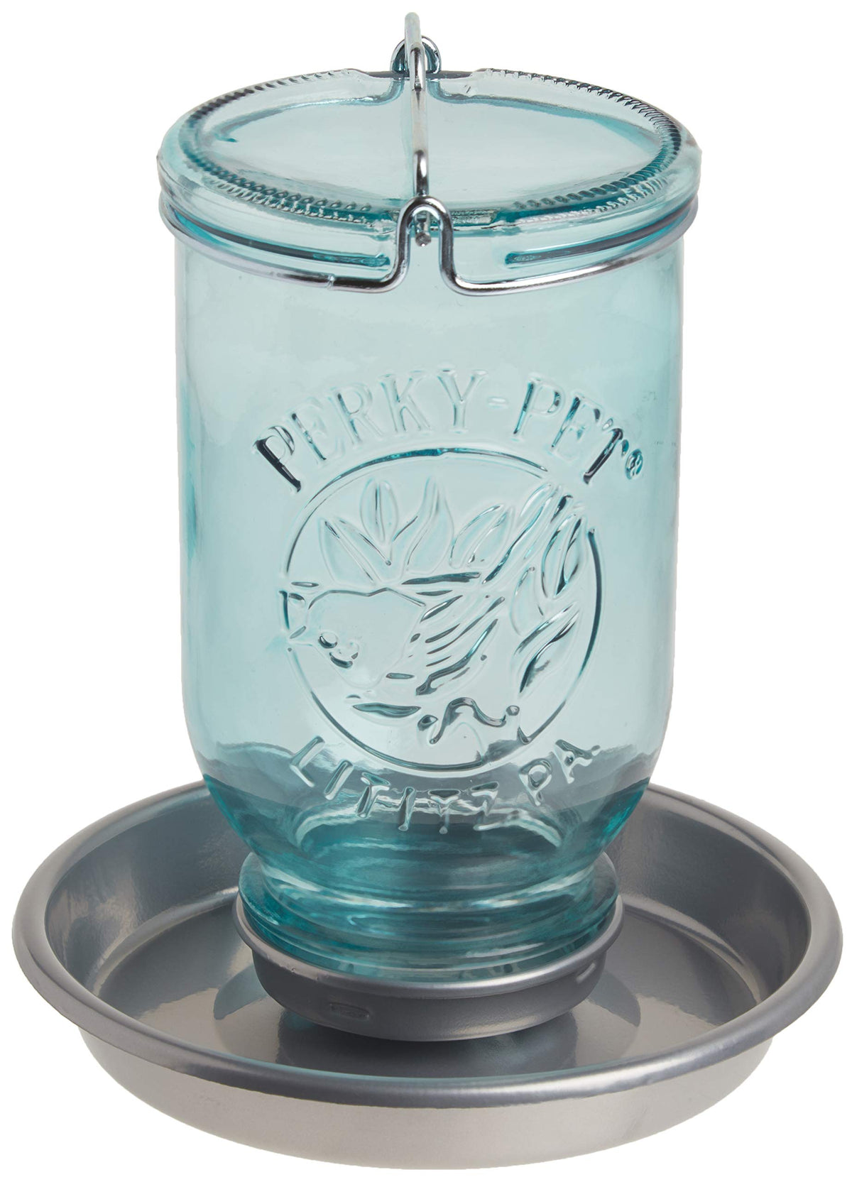 Perky-Pet Mason Jar Waterer blue bottle graces a garden, inviting birds with fresh water.