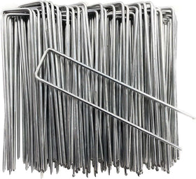 Petgrow 6 inch garden stakes securing turf and weed barrier for a neat lawn.