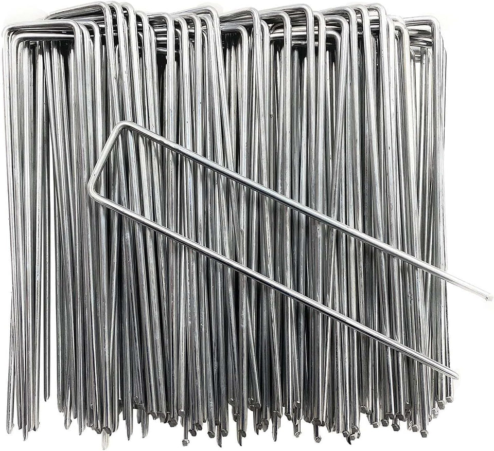 Petgrow 6 inch garden stakes securing turf and weed barrier for a neat lawn.