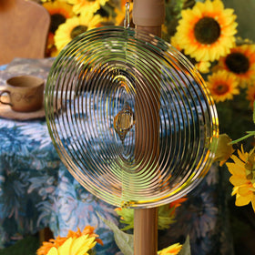 Phuryllic wind spinner round detail metal highlights sun-catch reflections.