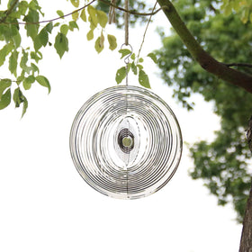 Phuryllic wind spinner round side view showing 3D motion in the yard.