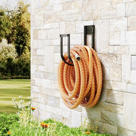 Pickpiff yard scene with hose neatly stored on wall mount.