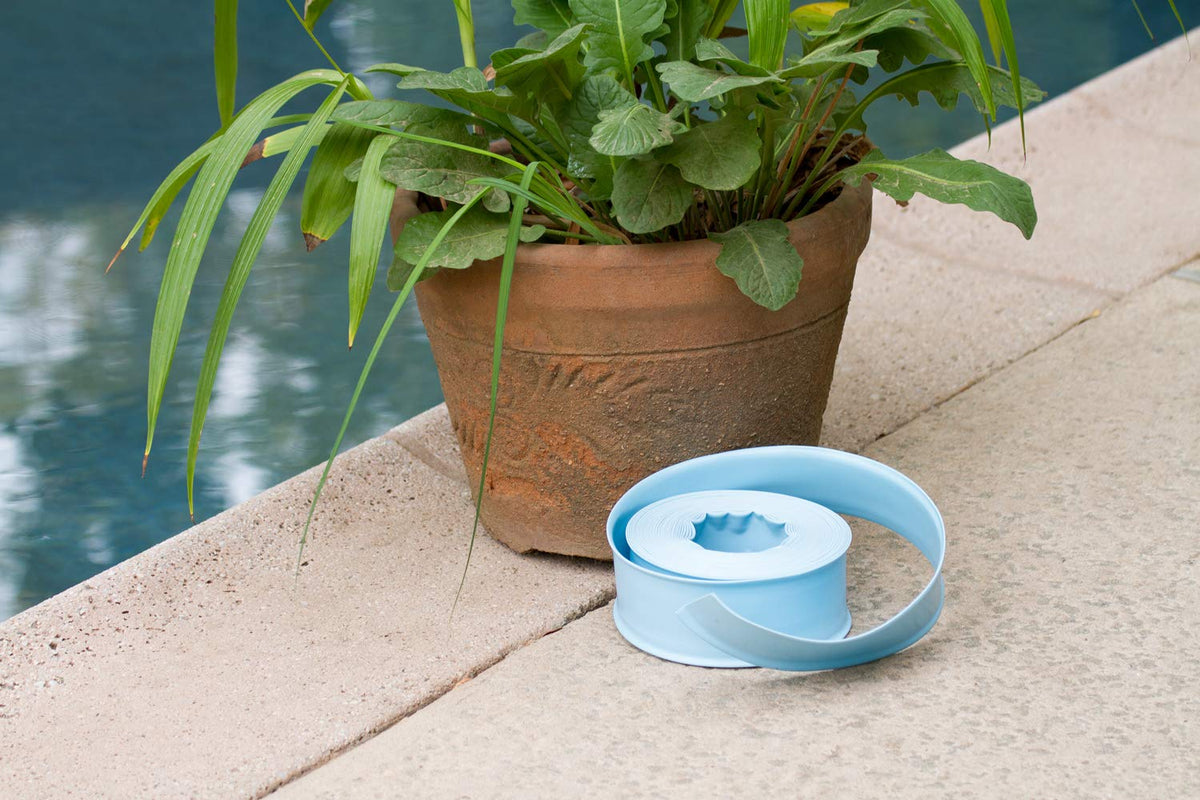 Poolmaster backwash hose rolled flat for compact storage after use.