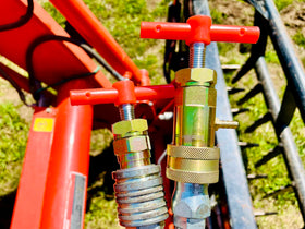 Red grip handle detail on PT Squared Trading Co relief tool for easy handling