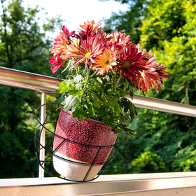 Pumtus black balcony planter on a rail adding vibrant greenery to a porch