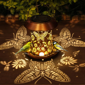 PWOOME solar bird feeder with butterfly lantern hanging on a tree for garden decor and bird viewing.