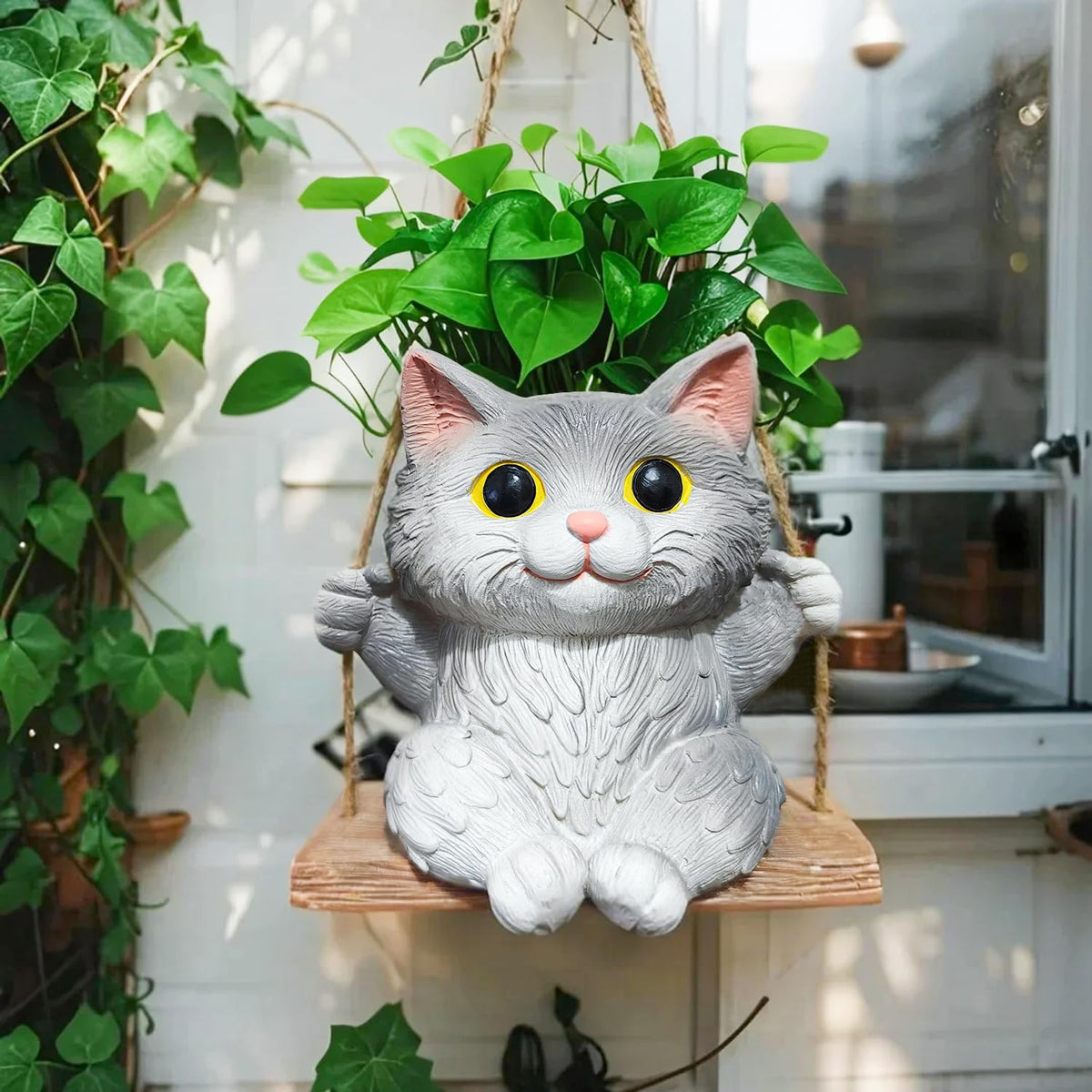 Pyoimmne cat hanging planter with succulent display on a sunny windowsill