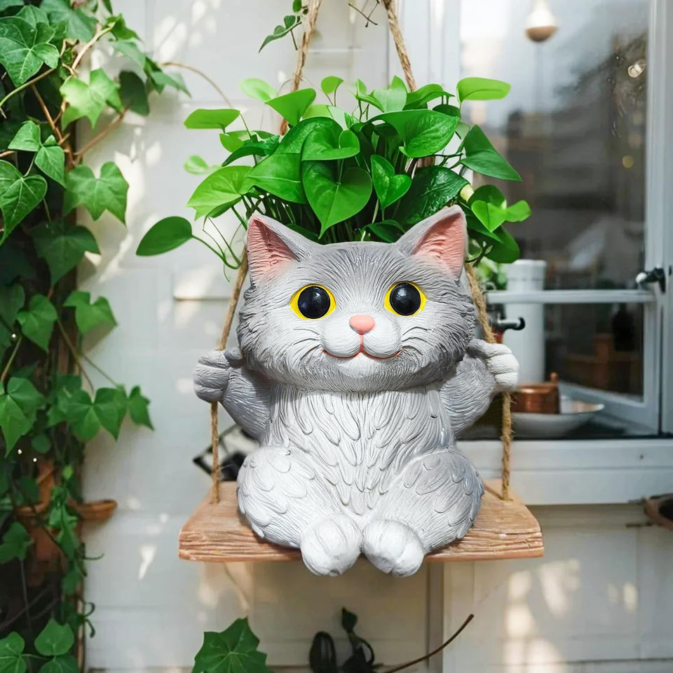 Pyoimmne cat hanging planter with succulent display on a sunny windowsill