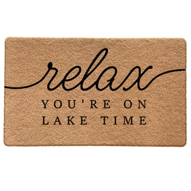 Qabliqo Lake House Door Mat at the front door with nautical welcome design traps dirt.