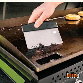 Qfire griddle scraper on Camp Chef, heavy-duty stainless steel for durable cleaning