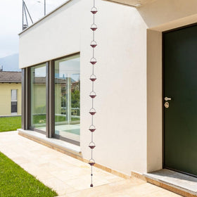 Decorative rain chain enhances porch, garden, or doorway with elegant visuals.