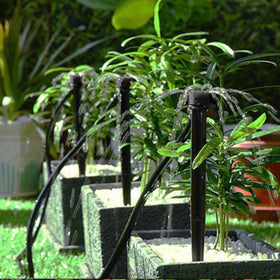 QMOEH soil-insert emitter shown in soil for root-zone watering