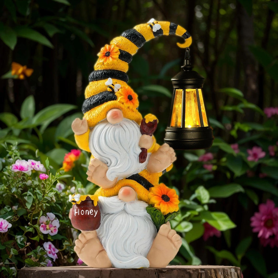 QZZP Solar Bee Garden Gnomes with LED Lantern light up dusk garden paths for a cozy outdoor ambiance.