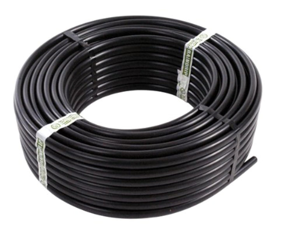 Raindrip supply tubing main line delivering water to garden beds