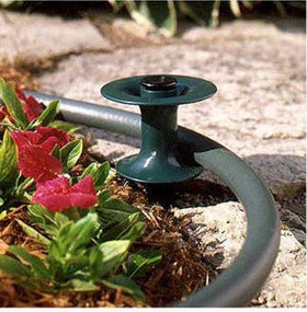 Rocky Mountain Goods hose guide spike green blends with yard for discreet hose management.