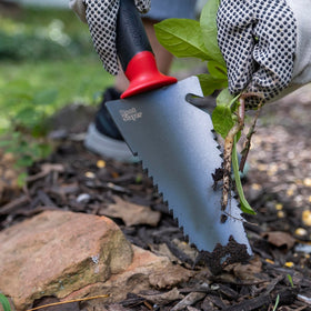 Root Slayer trowel in garden use demonstrates versatile root cutting