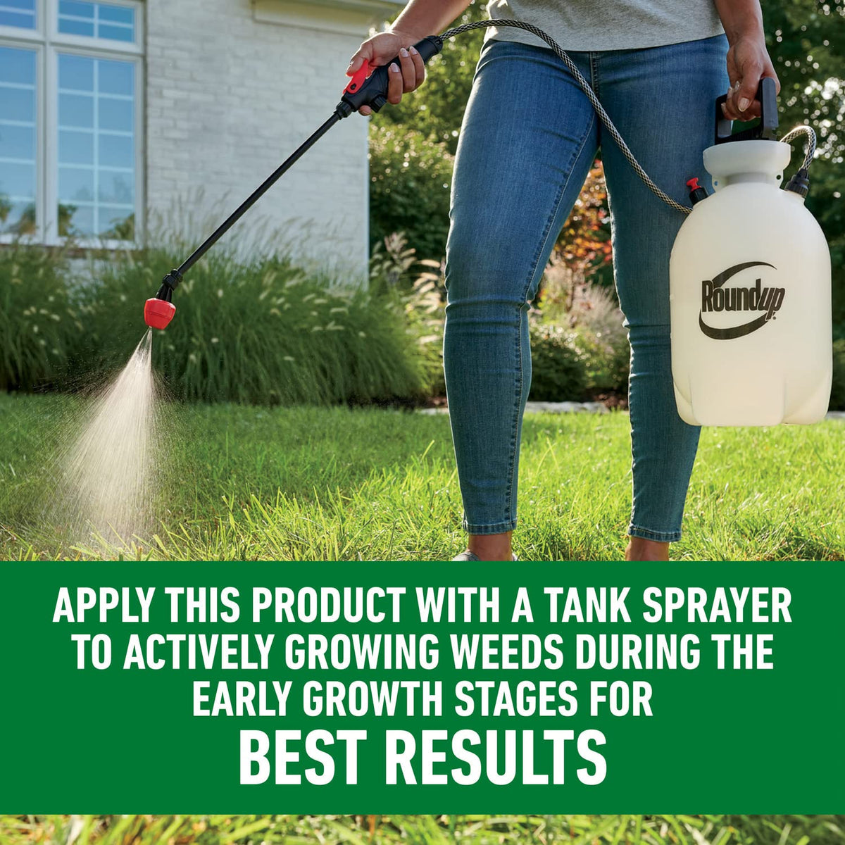 Roundup For Lawns₂ Concentrate mixing with water in a tank sprayer.