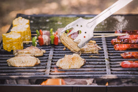 Roxon S601 spatula flipping burgers on hot grill.