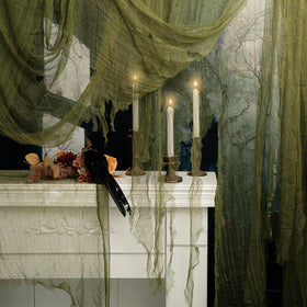 RunNico green cheesecloth rolled for quick Halloween setup and dramatic doorway effects.
