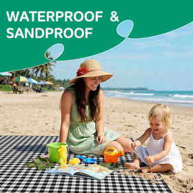 RYCHIC sandproof blanket laid out for beach day and games.