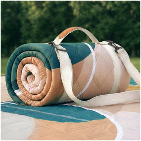 RYCHIC waterproof picnic blanket on grass for damp outdoor picnics.
