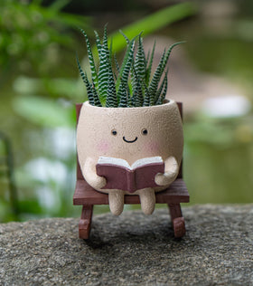 RZOIKZOI smiley planter close-up on rocking chair