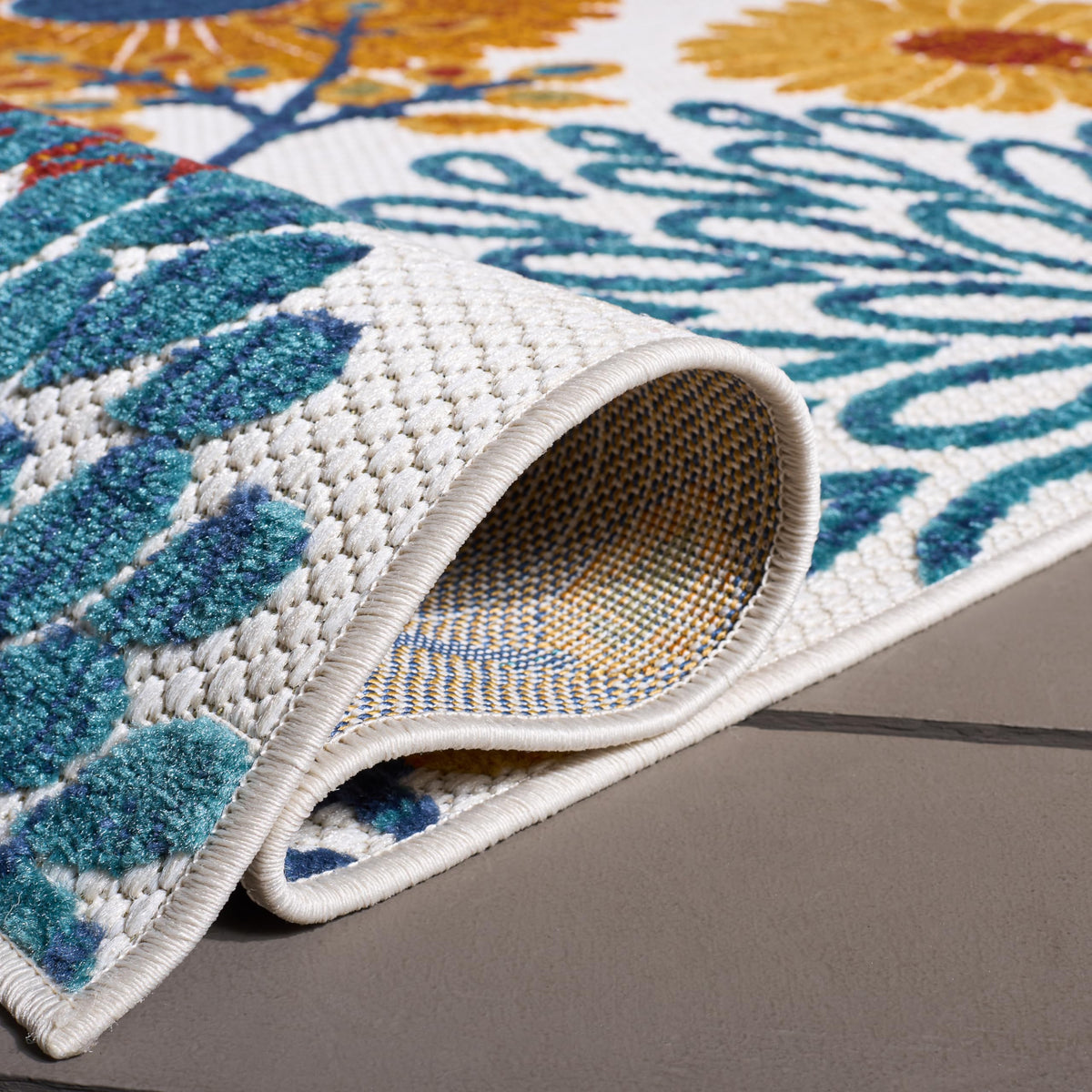 Safavieh Cabana rug beside patio furniture for weather-ready styling