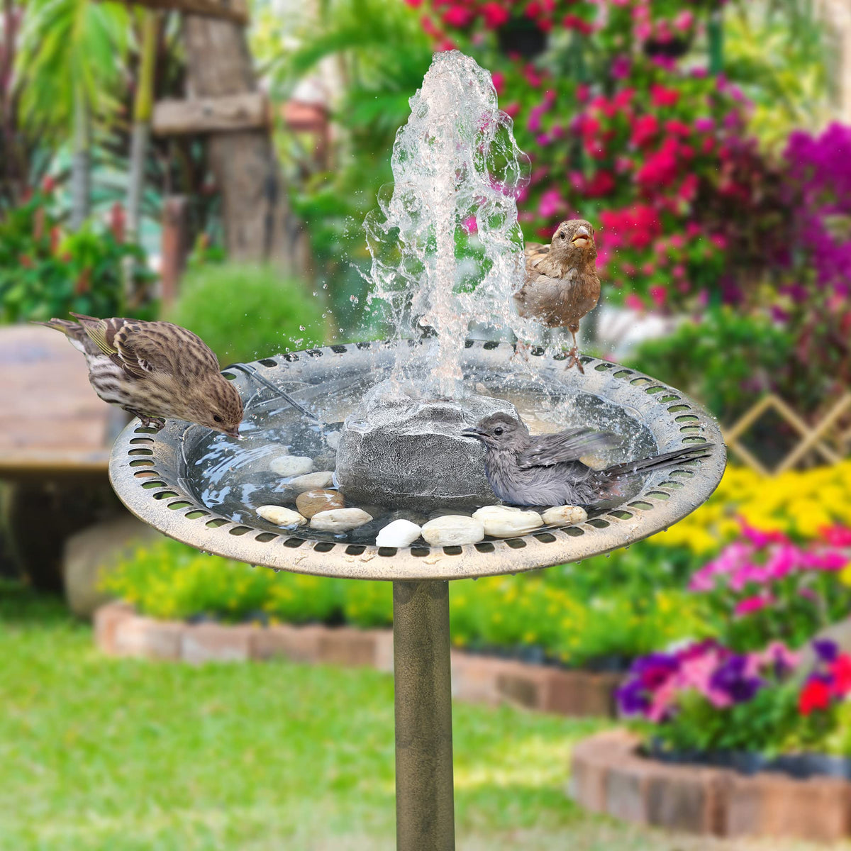 Saillong bird bath waterfall pump providing flowing water for a serene garden feature.