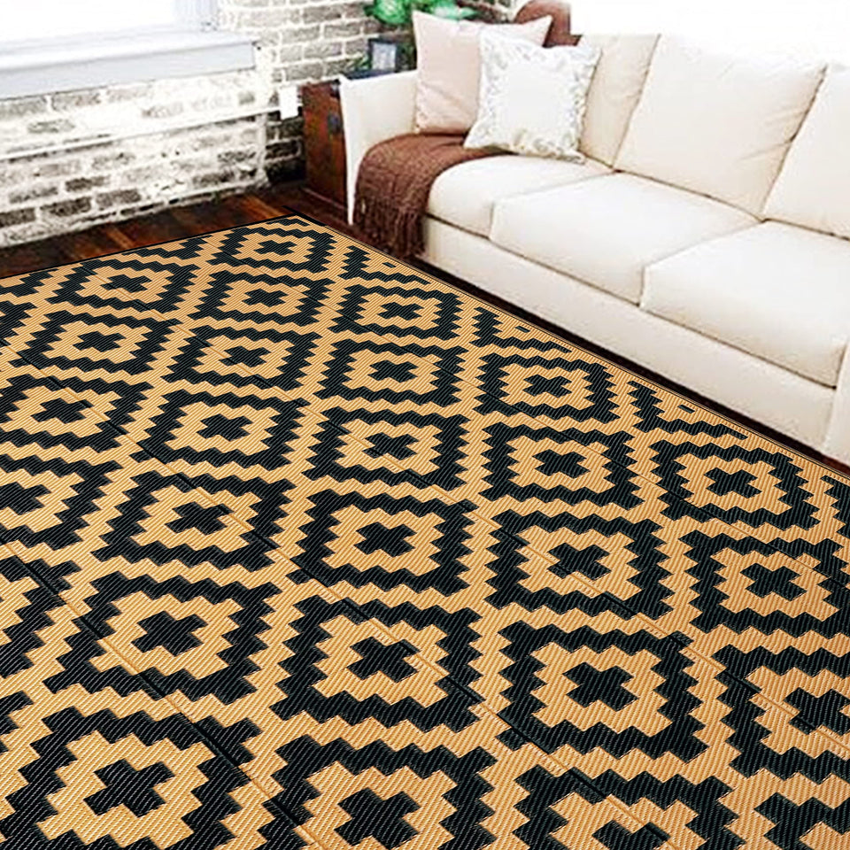 SAND MINE reversible mats on a patio with outdoor furniture for gatherings.